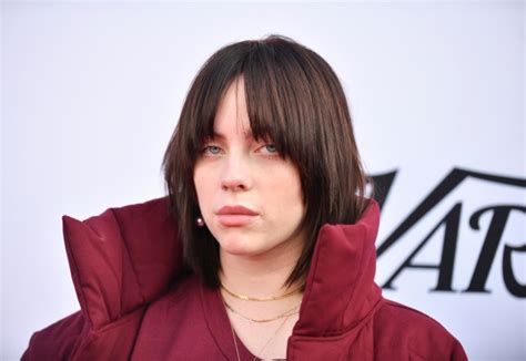 Billie Eilish flashes hidden chest tattoo while sunbathing in bikini ...